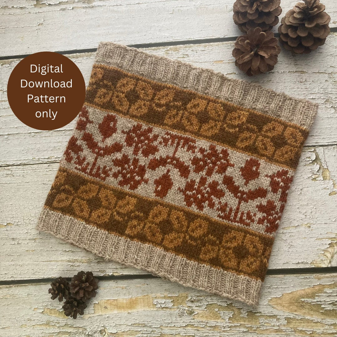 A knitted cowl with a Fair Isle Stranded Colourwork style pattern in brown, rust red, and cream, displayed on a rustic white wooden surface with pinecones. A brown circular badge on the left reads 'Digital Download Pattern only'.