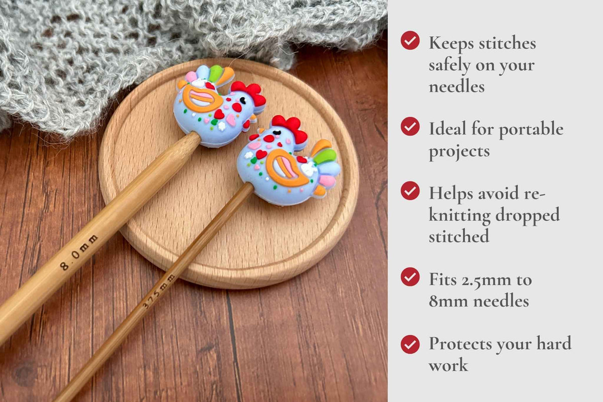 Two wooden knitting needles with colourful chicken-shaped stitch protectors rest on a round wooden tray, with a knitted fabric nearby and a text panel on the right describing benefits. Keeps stitches on needles. Ideal for portable projects. Helps avoid re-knitting dropped stitches. Fits mm to 2.5mm to 8mm needles 