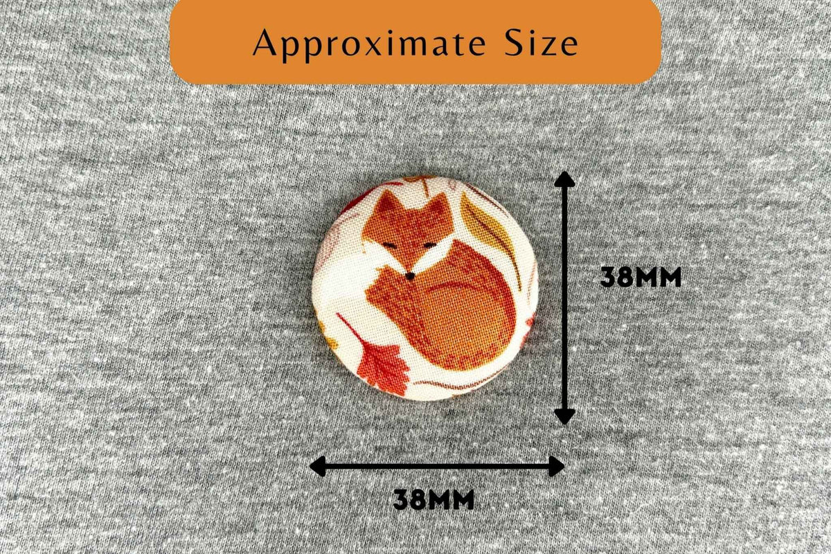A round fabric magnetic needle minder with a fox illustration on a gray fabric background, with black arrows and text indicating approximate size 38mm by 38mm.
