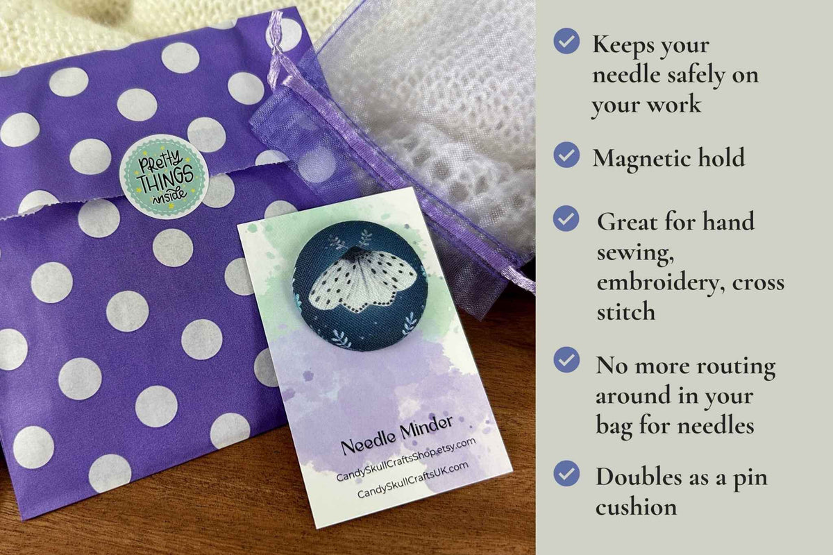 A product presentation of the magnetic 'Needle Minder', showing a purple and white polka dot paper bag, a purple mesh bag , alongside a text overlay detailing the product features.keeps your needle safely on your work. Magnetic hold great for hand sewing, embroidery, cross stitch. No more routing around in your bag looking for needles. Doubles as a pin cushion.
