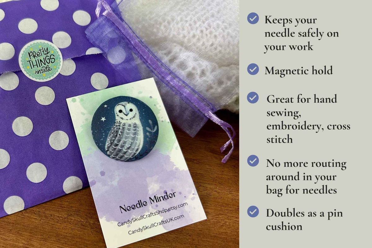 A product listing graphic showing a round magnetic needle minder featuring an owl. Packaged in an organza mesh bag, and a purple and white polka dot bag. The graphic lists the features on the right. keeps your needle safely on your work. Magnetic hold great for hand sewing, embroidery, cross stitch. No more routing around in your bag looking for needles. Doubles as a pin cushion.
 The brand 'Candy Skull Crafts' is visible on the card.