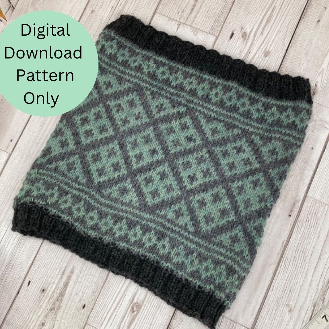 A knitted cowl or scarf with a green and dark gray Fair Isle diamond pattern, laid flat on a light wood plank background. A light green circular badge in the top left corner reads 'Digital Download Pattern Only'.
