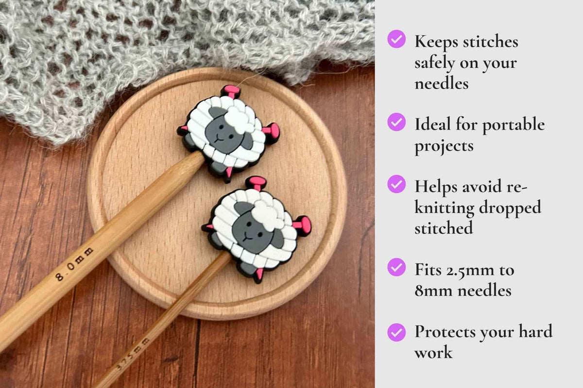 Two sheep-shaped knitting needle stoppers are displayed on a round wooden tray next to a knitted fabric, with a text panel on the right describing benefits. Keeps stitches on needles. Ideal for portable projects. Helps avoid re-knitting dropped stitches. Fits mm to 2.5mm to 8mm needles 
