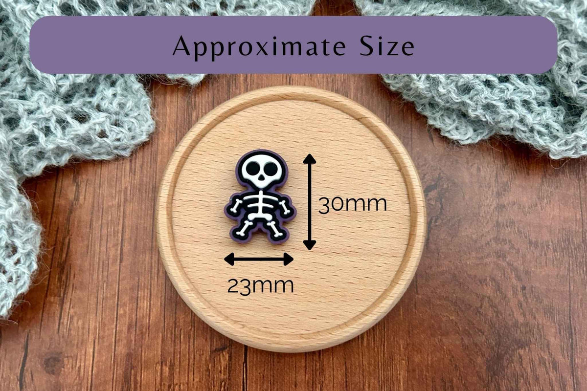 A single skeleton knitting needle stopper on a round wooden board with measurement arrows and text reading 'Approximate Size,' indicating dimensions of 30mm by 23mm. 