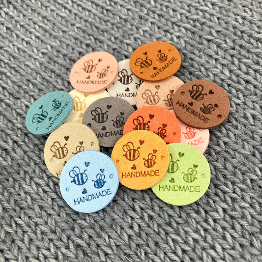14 Round Bee Labels “Hand Made”, made from PU Pleather Faux Suede. Clothing Sew On Tags for Knitted, Crochet or Sewn Garments, Craft labels.